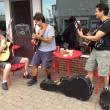 Outside of Red Cup Coffeehouse, owner/musician Paul Johnson (left) jams with jazz guitar legends Frank Vignola and Vinny Raniolo. JOE GELARDEN/Boothbay Register