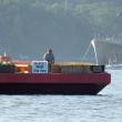 Pyrotechnic Austin Hills prepares for the Fourth of July fireworks show aboard the barge in Boothbay Harbor.  GARY DOW/ Boothbay Register