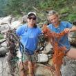 Michelle Levano and Marina Garland pick up trash on the shores of Hurricane Island before returning to Boothbay on June 24. Courtesy of the Rozalia Project
