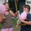 A young girl and boy enjoy some cotton candy at the Camp K Carnival. KEVIN BURNHAM/Boothbay Register