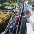 A young boy watches as kayaks are carried down to the dock on August 10. SUE MELLO/Boothbay Register