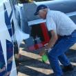 Dave Murphy, father of Texas Flying Legends Museum Warbirds pilot Mark Murphy works August 5 to  clean the plane his son would fly Tuesday. The elder Murphy owns the P-51. SUSAN JOHNS/Wiscasset Newspaper