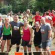 Looking a little wearier but undaunted local teammates pose with another participant at the end. Courtesy of John Mitkus 