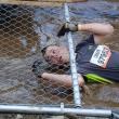 Jared Mitkus enters the mud pool/chain link fence crossing. Courtesy of John Mitkus