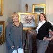 Kathleen Billis, left, and COCO VIVO Fine Art owner Mary Phelps. The Billis work on the easel, “A Northern Farm” in Waldoboro is just one of the new works in a series called, “Feels Like Home” running through August 31. LISA KRISTOFF/Boothbay Register