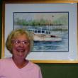 Virginia Forrest stands in front of her watercolor entitled "Boothbay Harbor Lobster Boats."