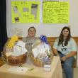 Chelsea Graves, left, and Tabetha Harrington are in charge of selling raffle tickets to benefit the Lincoln County K-9 program at the Hometown Heroes event. KEVIN BURNHAM/Boothbay Register 