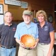 Master woodturner Lou Landry donates a handcrafted bowl to the Boothbay Charities Classic for the third consecutive year. Pictured from left are Mike Feldman, chairman of Special Olympics Maine, Lou Landry and Brenda Blackman, co-chairman of the Charities Classic. Landry's woodworking has spanned over 50 years. His studio, Ocean Point Woodturning on Van Horn Road, features unique bowls and vases, both segmented and unsegmented wood composites consisting of many colors and textures. This year, Landry's bowl 