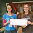 Lincoln County Animal Shelter receives a $300 donation as the July recipient. Elya Markert, Rising Tide Outreach Coordinator, left, presents the check to Carrie Koskela, Lincoln County Animal Shelter office manager. Courtesy of Rising Tide