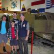 World War II veteran and museum volunteer Austin Carter provides a tour of the Cole Transportation Museum to Southport Scouts Jake Brewer (left), Liam Cullina (middle) and Jacob Bishopp (back). Courtesy of Sarah Sherman