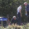 Officer Richard Mirabile talks with accident victim William Anderson sitting on the grass beside Route 96. KEVIN BURNHAM/Boothbay Register