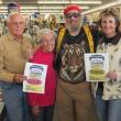 Big Al Cohen hands out contest gift certificates to Mark Powley and his wife and Linda Campbell, right. 