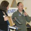 Lt. Col. Tyler Blake of the Air National Guard presents a special flag and photograph to club president Jennifer Page Osman. KEVIN BURNHAM/Boothbay Register