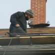 Photo of Josh Gallant of Augusta working on the roof of the 1811 jail in Wiscasset