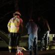 Wiscasset Fire Chief T.J. Merry, left, an unknown man and Alna Assistant Fire Chief Roger Whitney look down to where fellow rescuers were returning down a banking and into the water. SUSAN JOHNS/Wiscasset Newspaper