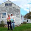 Faith and Joel Vittori hold the waste can behind Ernestine Dodge’s garage. SUZI THAYER/Boothbay Register