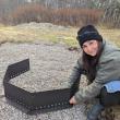 Program Manager Misha Barker sets up a firepit for BRES's new outdoor classroom. Courtesy of Erin Quinley