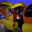 The Wienermobile and one of the drivers