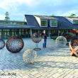 Jay "JBONE" Sawyer of Warren and a few of his spheres in his "Spiritual Influence" installation at CMBG. 
