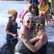 Hugging at 2024’s Wander Women’s dip in Union are Carla Armbuster and Carol Miller. In back, left to right , are Cathy Kelly, Kerry Hadley, Emily Peckham, and Laura Cabot. This year's event will be held on Feb. 9.  Photo by Erja Lipponen