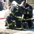 Lieutenant Jonathan Tindal (kneeling) and Firefighter David Washburn donning Self Contained Breathing Apparatus and preparing to enter the building. Courtesy of Mark Sullivan