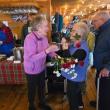 Dee and Howard Wright present roses to Community Lunch volunteer Nancy Van Dyke. Darrell Gudroe photo