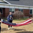 Edgecomb Eagles folding the flag are Isabel, daughter of Cashel and Brian Fanslau; Mason, son of Nicole McKay and Patrick Wenners; and Andrew, son of Amanda and Andy Main.  Students are residents of Alna and Edgecomb. Courtesy photo
