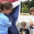 Making sure the flag is handled properly are Maxine, daughter of Pascale and Kirk Zehm;  Sam, son of Daniel and Maureen Cooper;  and Mason, son of Nicole McKay and Patrick Wenners. Students are residents of Alna and Edgecomb. Courtesy photo