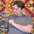 Author Samuel Hewson with an artificial intelligence mock-up of the cover for his book first "All Aboard" a time travel adventure.  Eleanor Busby photo