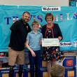 6th grader Duncan Scott helps present the ceremonial check to his chosen charity, the Travis Mills Foundation. Pictured: Travis Mills, Duncan Scott, and principal Lisa Clarke. ISABELLE CURTIS/Boothbay Register