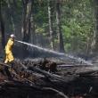 A firefighter sprays hotspots in Waldoboro, Aug. 9, 2025, during a brush fire. Two days later, Aug. 11, St. George firefighters extinguished an approximate 30' x 30' brush fire on inner edge of a quarry off River Road. (Photo by Sarah Thompson)