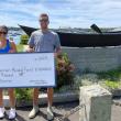 Tuna Challenge Chairman and Carousel Marina Manager Jax van der Veen and Dock & Facility Manager Evan Hepburn with last year's donation check. SARAH MORLEY/Boothbay Register