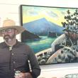 Brunswick-based artist Matt Barter stands in front of his father, Philip Barter's painting, "Spring Evening Grindstone," at the opening reception of their father-son show at Kerr + Jones Fine Art in East Boothbay Sept. 17. LISA KRISTOFF/Boothbay Register