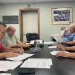 Boothbay Harbor Sewer District trustees overlook their draft agreement with Coastal Maine Bontantical Gardens. Pictured, from left: Russell Hoffman, Jim Stormont, Chris Higgins and Deryl Kipp. 