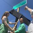 From left, Heather Jones and State Sen. Rachel Talbot Ross unveil one of the new signs naming the Main Street, Wiscasset railroad crossing James Weldon Johnson Crossing, as Terry Heller holds a phone on which Johnson’s great niece Melanie Edwards and Tony Hill, past lawmaker in Johnson’s native Florida, attend via Zoom June 26. Johnson, the poet-civil rights advocate who wrote the words to “Lift Every Voice and Sing,” died in a car-train crash at the crossing in 1938. SUSAN JOHNS/Wiscasset Newspaper 