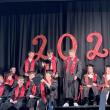 Some of their seated classmates look on as three graduating Wiscasset Middle High School seniors share a moment June 5. SUSAN JOHNS/Wiscasset Newspaper