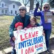 Rita Arnold and her granddaughters, June and Faye, protest the federal funding cuts to libraries nationwide. ISABELLE CURTIS/Boothbay Register