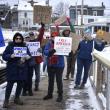 Locals walk down the footbridge in Boothbay Harbor as part of the national "Free America" protest. ISABELLE CURTIS/Boothbay Register