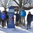 After much shoveling, nailing and adjusting, the Boothbay Region Student Aid Fund's new sign is installed on the high school lawn Feb. 4. Pictured:  Sarah Baldwin, Chip Schwehm, Zander Blake, Nathan Percival, Harry Hinkley, Abby Orchard, Hildy Johnson, Chris Liberti and Preston Giles. Not pictured: Brandon Seigars, Mathew Jackson, Spencer Wood and Cameron Lewis. 
