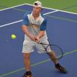 Griffin Yereance makes a backhand return against his Madison opponent. KEVIN BURNHAM/Boothbay Register