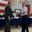 Mike Tomko presents a representative of U.S Coast Guard Boothbay Harbor with the Spirit of America Tribute. ISABELLE CURTIS/Boothbay Register
