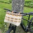 Workshop participants may choose to weave either a bike basket like this one, or a gathering basket with a wooden swing handle. Courtesy of Coastal Rivers