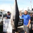 Nick Morley with his 694-pound tuna. STEVE EDWARDS/Boothbay Register