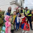 A group stops for a photo with Boothbay Harbor police officers near Grover's Hardware during the 2025 parade. Bethany Schmidt photo