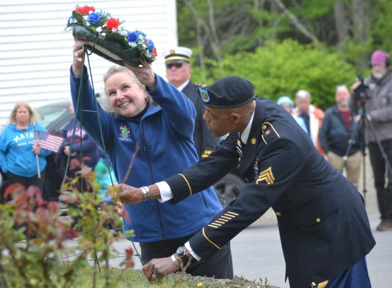 2024 Memorial Day Grand Marshal Sarah Sherman and Legion Post #36 Americanism Officer Christopher Armstead place a wreath at the Southport memorial. File photo