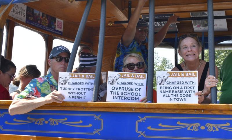 The trolley got a prison-themed makeover July 16 as locals hopped aboard to raise "bail money" for continued maintenance of the historic vehicle. (from left) Alan Osborn, Tricia Campbell and Lisa Osborn. ISABELLE CURTIS/Boothbay Register