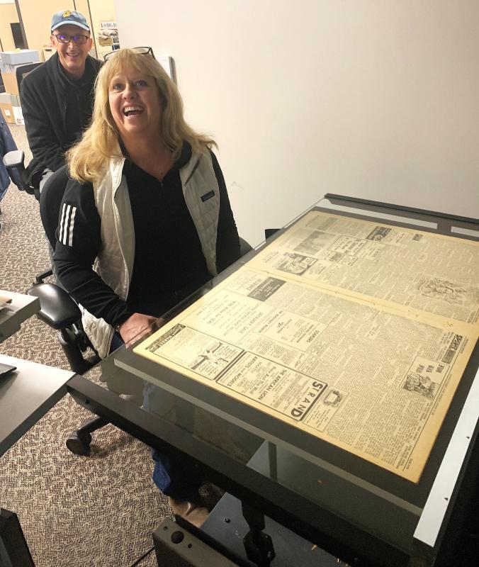 Sarah Morley and Larry Brown take a turn scanning a historical Boothbay Register on the Maine State Library's state-of-the-art machine. KEVIN BURNHAM/Boothbay Register