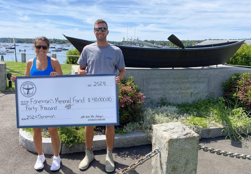 Tuna Challenge Chairman and Carousel Marina Manager Jax van der Veen and Dock & Facility Manager Evan Hepburn with last year's donation check. SARAH MORLEY/Boothbay Register
