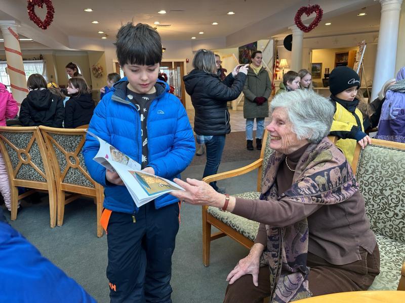 A BRES third grader shares a book with Village resident Leigh Sherrill. Courtesy photo