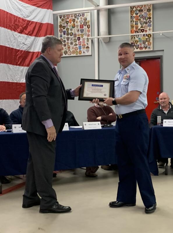 Mike Tomko presents a representative of U.S Coast Guard Boothbay Harbor with the Spirit of America Tribute. ISABELLE CURTIS/Boothbay Register